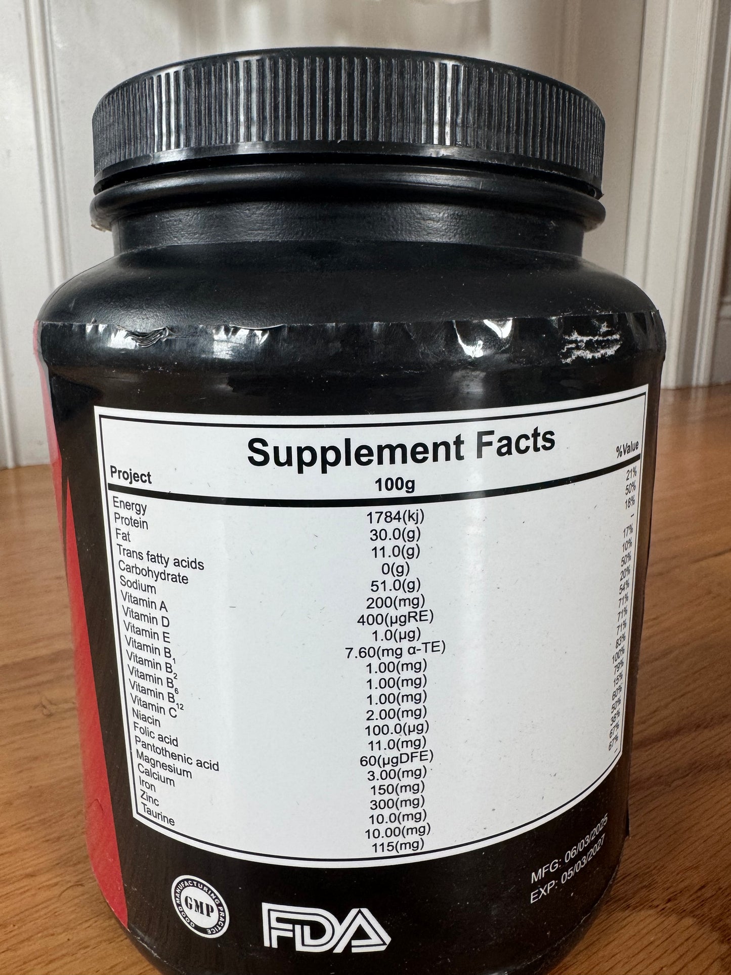 Supplement container with label on a wooden surface